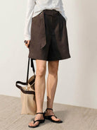 White 100% linen belted shorts with relaxed wide-leg fit and high-rise waist