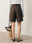 White high-rise linen belted shorts with relaxed wide-leg fit and matching fabric belt