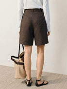 White high-rise linen belted shorts with relaxed wide-leg fit and matching belt detail