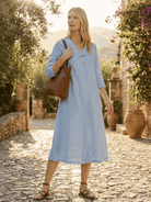 Woman wearing navy linen-look midi dress with 3/4 sleeves and side pockets