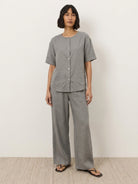 Women wearing 100% cotton two-piece set with button-front top and wide-leg pants in soft solid colors