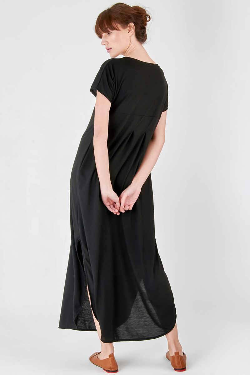 Black side slit maxi dress with pockets and rolled sleeves, relaxed fit floor-length design.