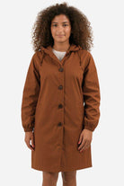 Water Resistant Oversized Windbreaker rain jacket in brown with hood and button closure worn by woman
