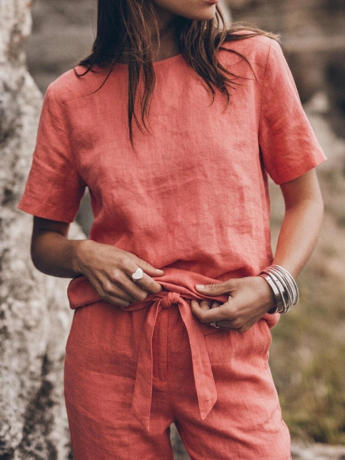 Woman wearing a relaxed fit cotton linen set with short-sleeve top and straight-leg pants in monochrome tones