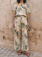 Woman wearing soft-tailored loose fit co-ord set with wide-leg bottoms in light cotton fabric