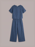 woman wearing loose fit co-ord set with boxy top and wide-leg trousers in soft cotton fabric