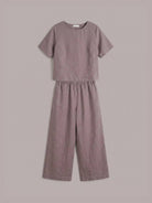 Woman wearing a soft cotton loose fit co-ord set with a relaxed boxy top and wide-leg trousers in a light, breezy fabric