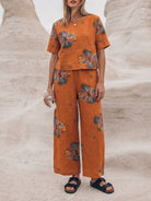 woman wearing loose fit co-ord set with soft-tailored top and wide-leg bottoms in breathable cotton