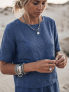 Woman wearing soft-tailored top and wide-leg bottoms loose fit co-ord set in light cotton fabric