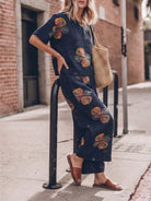 Woman wearing a soft cotton loose fit co-ord set with a relaxed short-sleeve top and wide-leg trousers