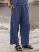woman wearing loose fit co-ord set with soft-tailored top and wide-leg cotton trousers in light color