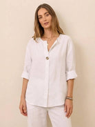 woman wearing white pure linen age-defying button detail shirt with rolled sleeves