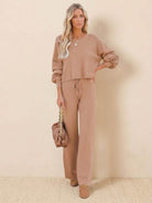 Woman wearing brown round neck loose fit cozy two-piece set with long sleeves and wide-leg pants