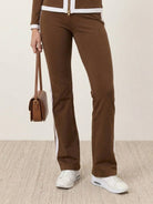 Woman modeling sleek contrast zip two-piece outfit with flattering silhouette and soft stretch fabric