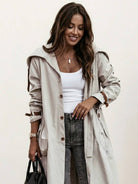 Minimalist hooded coat with sleek oversized fit for travel and lightweight warmth
