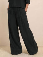 Black short-sleeved pullover and wide trouser matching set with deep pockets and wide cuffed hem