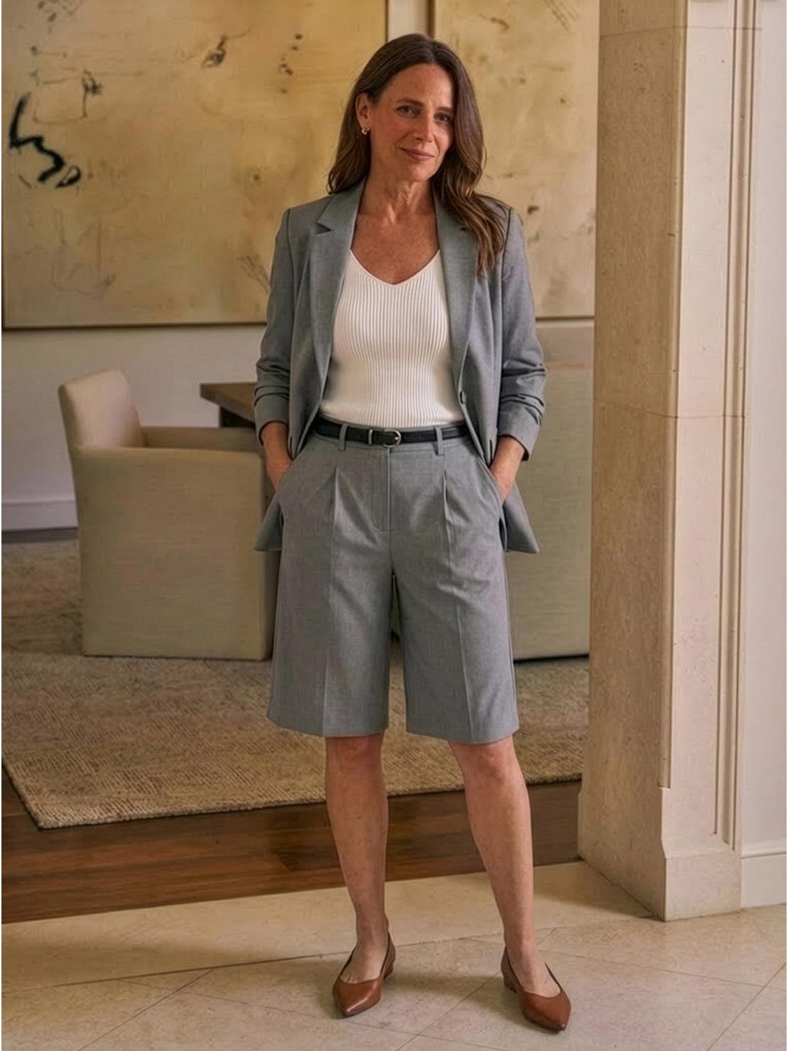 Woman wearing a stylish blazer and high-waisted shorts two-piece set in a polished, coordinated look