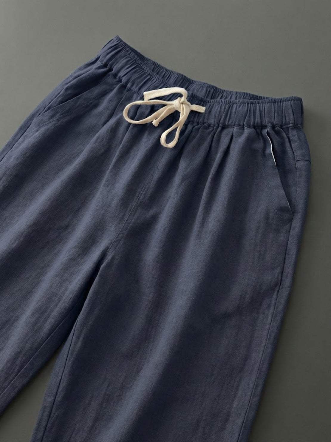 Woman wearing breezy relaxed fit straight pants in orange and black colors standing outdoors