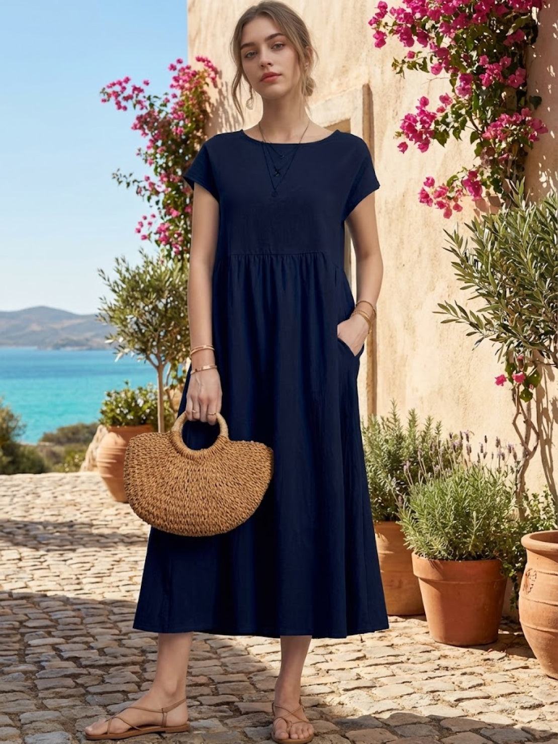 Woman wearing capped-sleeve voluminous pleated midi dress with flowy skirt and pockets