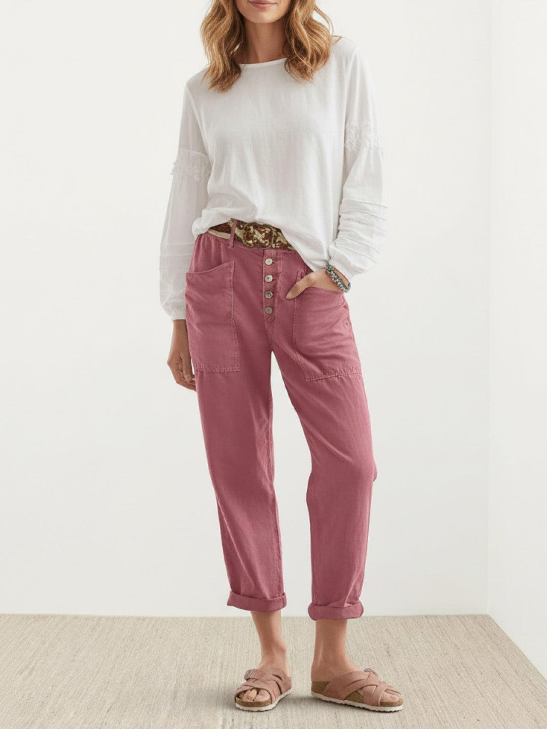 Woman wearing casual button-down utility-chic trousers with deep pockets and rolled cuffs