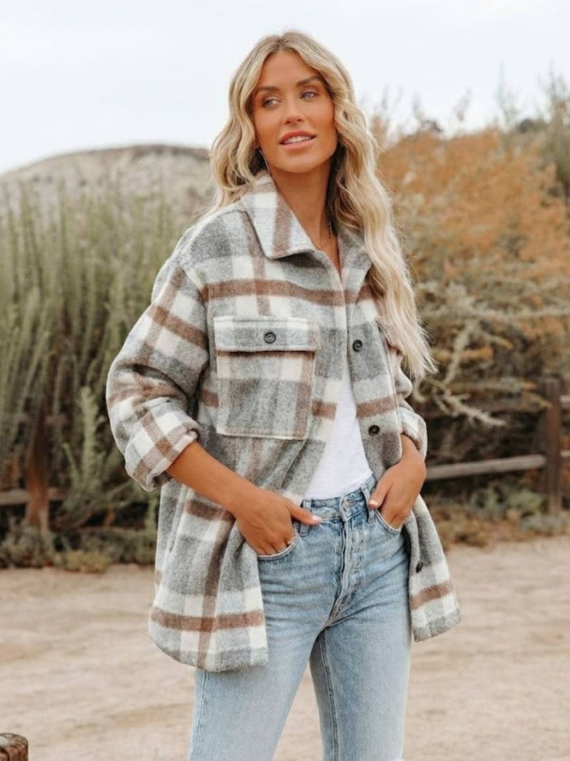 Woman wearing comfy flannel classic button-down shirt in beige and brown plaid with rolled sleeves outdoors
