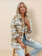 Woman wearing comfy flannel classic button-down shirt in beige and white plaid sitting on stool