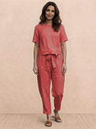 Woman wearing relaxed cotton linen set with short-sleeve top and straight-leg pants in monochrome tones