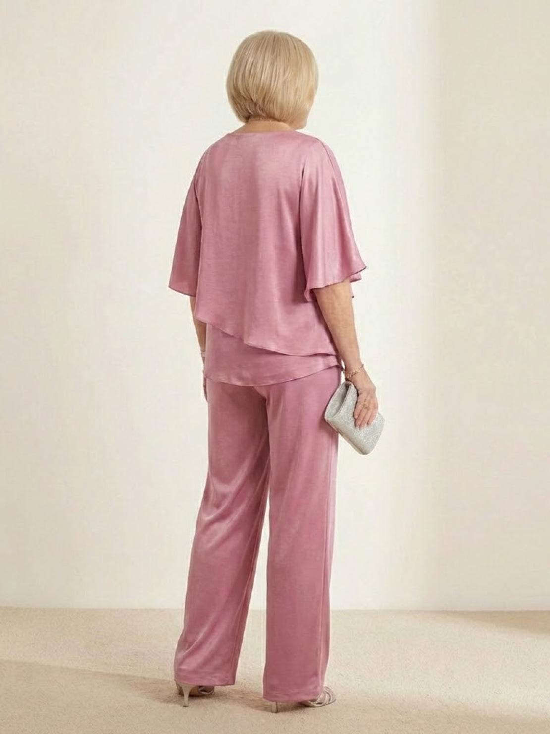 woman wearing Elegant Layers Two-Piece Set with layered V-neck top and matching pants