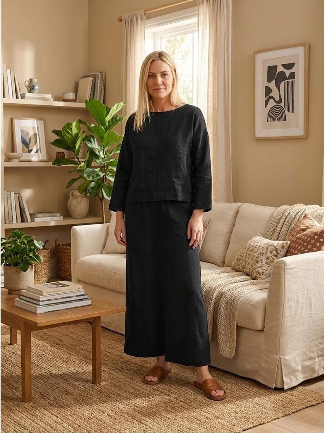 Woman wearing black loose solid color two-piece set in cozy living room