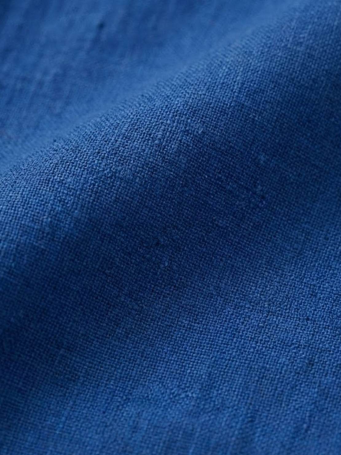 close-up of blue loose solid color linen-feel fabric texture