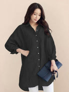 Oversized linen shirt in white cotton-linen blend with relaxed fit and back button detailing