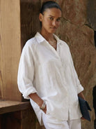 Woman wearing oversized linen shirt with relaxed fit and back button detailing