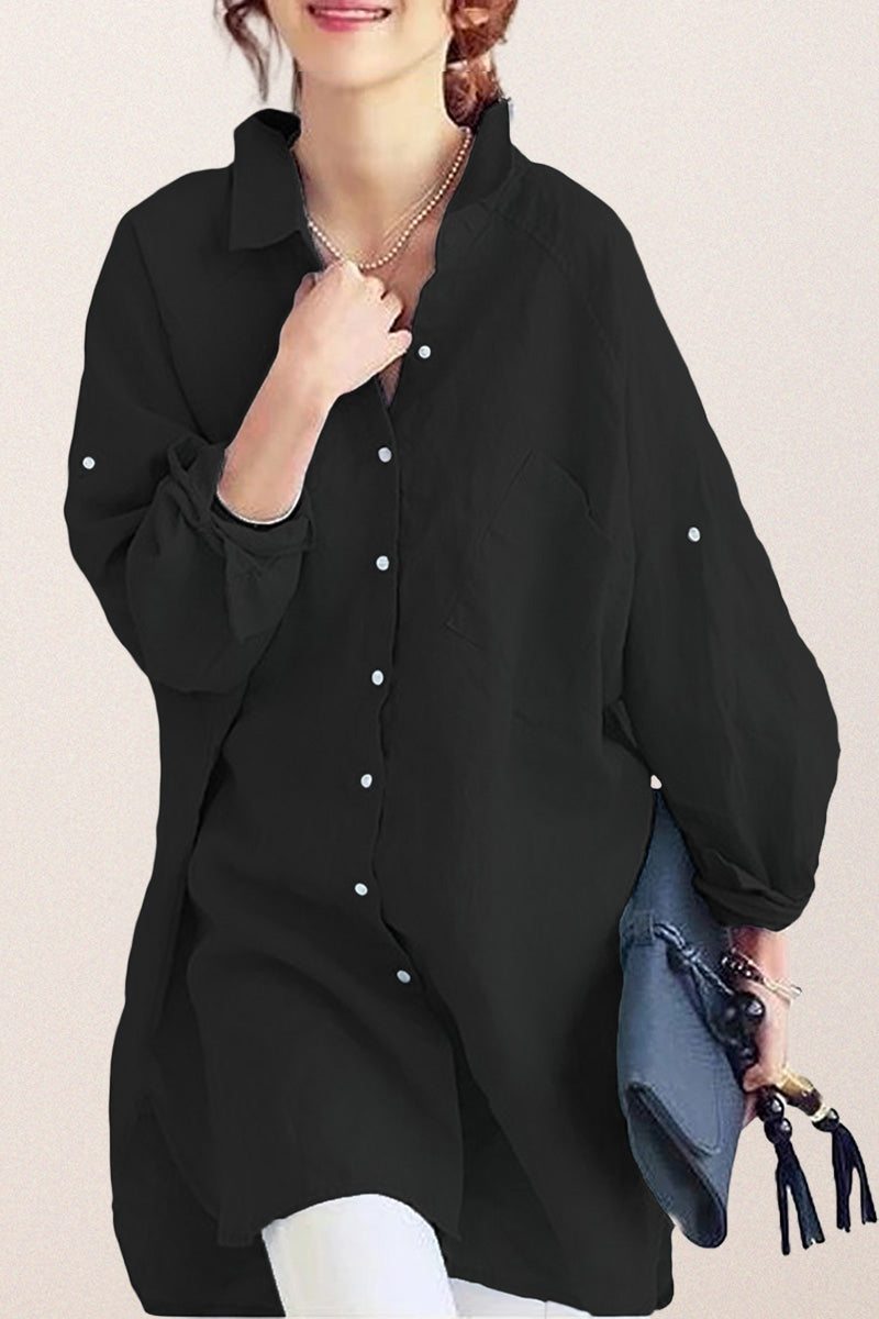 Black oversized linen shirt with relaxed fit and button details worn by woman holding blue handbag