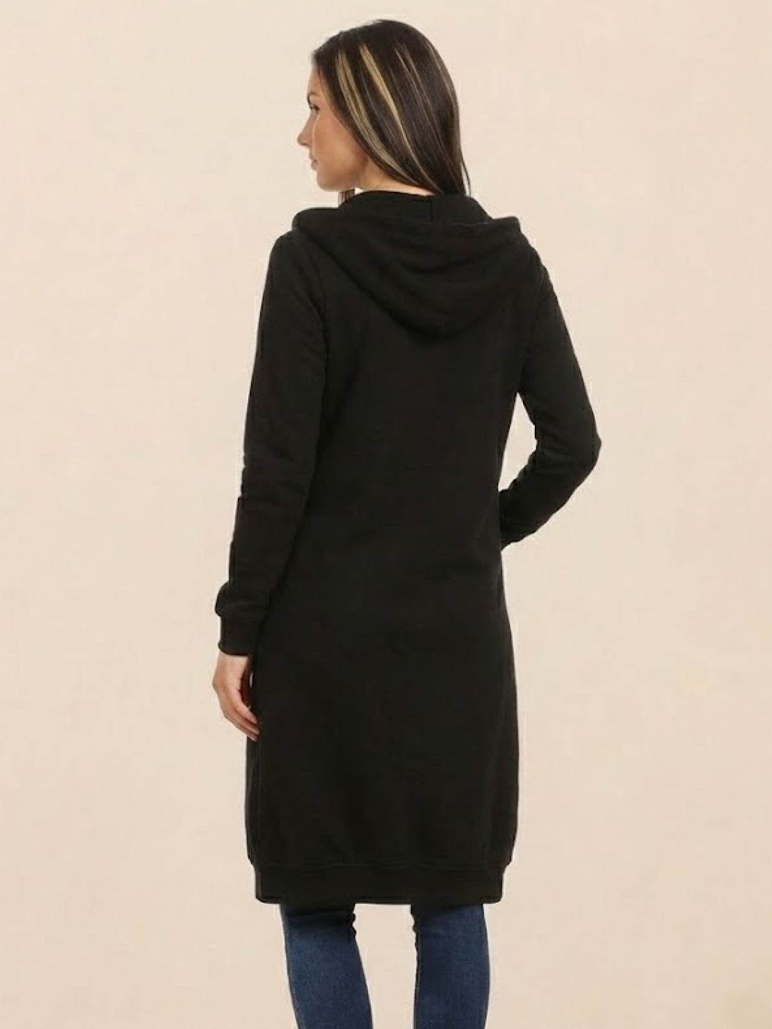 Back view of oversized long zip sweatshirt hoodie in black with hood and long sleeves worn by woman