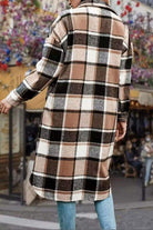 Oversized medium-length blue plaid overshirt in wool blend fabric worn outdoors