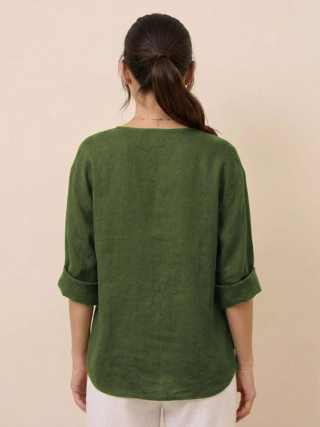 Back view of woman wearing green pure linen age-defying button detail shirt with rolled sleeves