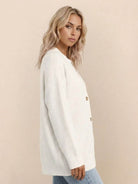 Relaxed fit oversized white knitwear cardigan with button down front on model