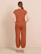 Woman wearing a comfy couture knit sweater two-piece set in soft, relaxed fit with matching pants