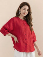 Woman wearing relaxed loose breathable linen red blouse with buttons and 3/4 sleeves