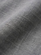 Woman wearing a relaxed shirt and trousers two-piece set in a casual, monochrome style