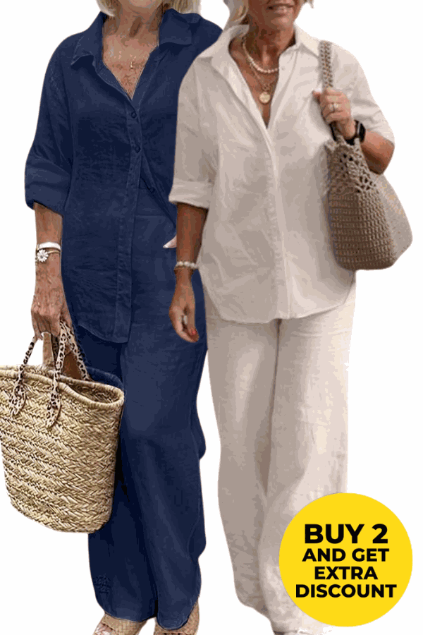 Two women wearing relaxed shirt and trousers two-piece sets in navy blue and white colors, casual loose fit, holding woven bags.