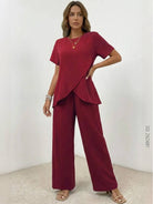 Woman wearing textured elegance two-piece set with asymmetrical top and wide-leg pants
