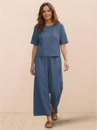 Woman wearing blue loose fit co-ord set with short sleeves and wide-leg pants
