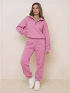 Woman wearing ultra-soft and comfy co-ord tracksuit set in pink with zip-up top and elastic waist pants