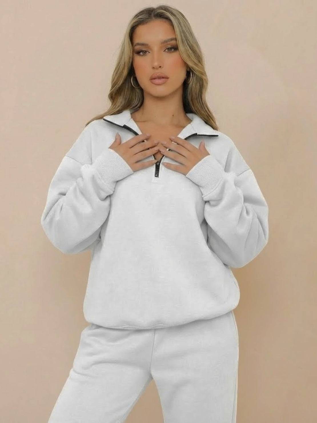 Woman wearing ultra-soft and comfy white co-ord tracksuit set with zip-up collar