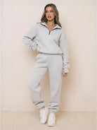 Woman wearing ultra-soft and comfy co-ord tracksuit set in light grey with zip-up top and matching jogger pants