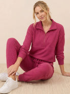 Unisex half-zip pullover and matching sweatpants set in soft fabric for casual comfort and everyday wear