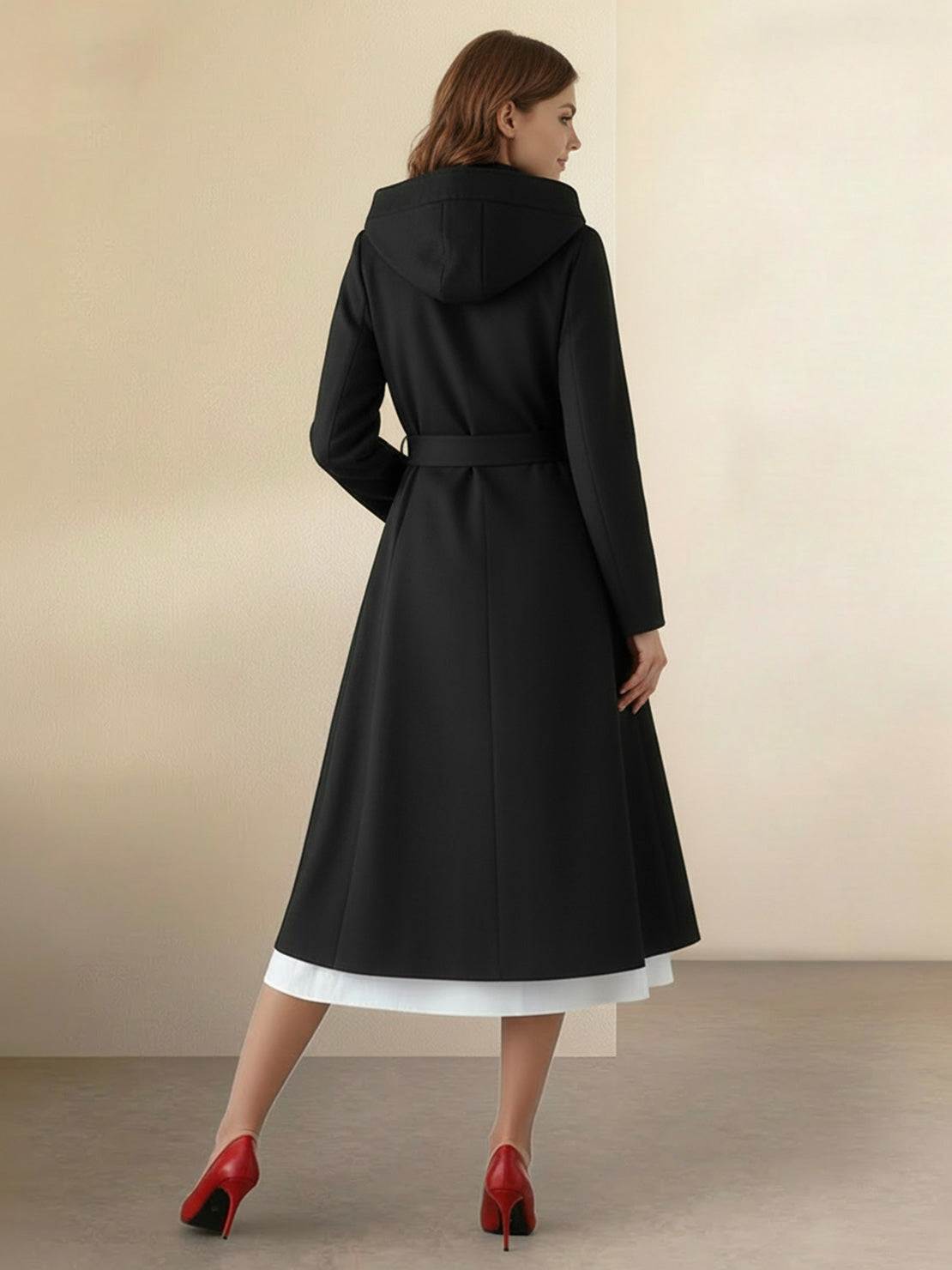 Woman wearing water-repellent rain A-line hooded raincoat with belt and insulated lining