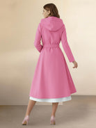 Woman wearing water-repellent A-line hooded raincoat with matching belt