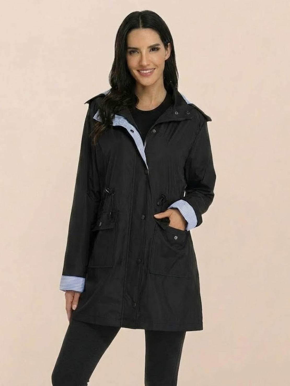 woman wearing black water resistant hooded striped windbreaker rain jacket with pockets